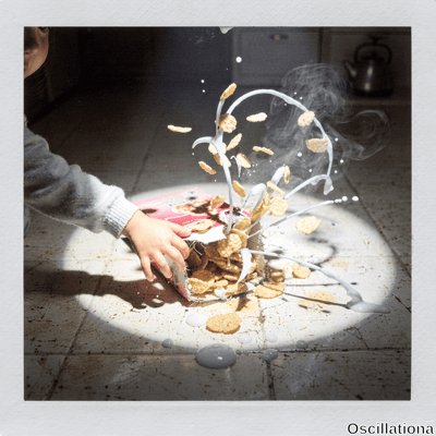Dramatic Instax freeze-frame of child's hand in sweater spilling golden cornflakes from pink box & white milk splashing on beige terracotta tiles, steam rising amid long shadows from spotlight lighting.