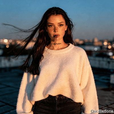 Freckled woman with wind-swept hair and hazel eyes in knit sweater on dusk rooftop has black tattoo with surreal strands from mouth to bokeh lights. 
The moody cinematic scene includes warm side lighting on her face and